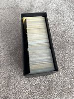 Pokémon Elite Trainer Box filled with Pokémon cards showing a large stack inside the box.
