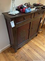 Full front view of cabinet with objects on top