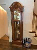 Full front view of the floor-standing oak veneer grandfather clock