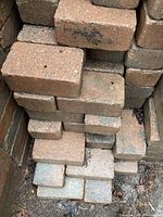 Stacked weathered rectangular patio stones showing surface texture and size