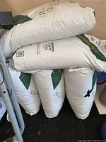 Five large white bags of horticultural super coarse perlite stacked with readable text showing brand and product type.