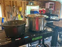 Photo showing Fresco pressure cooker with lid and one bundt cake pan on shelving in backyard garage
