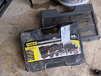 Closed carrying case of Stanley 99-piece black chrome socket set showing label and minor dirt and wear.