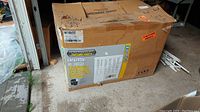 Cardboard box labeled Outdoor Factory Parts Universal 42 inch two bin grass bagger