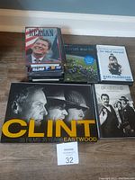 Photo showing a stack of DVDs including the Clint Eastwood collection large box, Reagan, Planet Earth, An Idiot Abroad, and Deadwood Complete Series