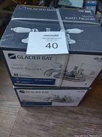Two Glacier Bay Teapot bath faucets boxes stacked; boxes show Chrome finish and some product details.