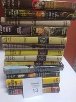 Stack of 14 vintage hardcover mystery books showing titles and series, including The Hardy Boys and Nancy Drew.