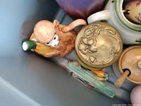 Photo showing monkey teapot, round beige floral container, tan pot with lid, and various glass pieces