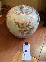 Full view of round Asian ceramic bowl with lid, showing general shape and painted design