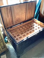 Open trunk showing removable lattice wood tray and underside of lid