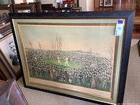 Full view of framed print leaning against furniture