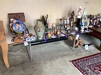 Overview of the coffee table showing glass top and acrylic legs with various other items placed on top for scale and context.