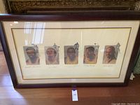 Front view of framed art piece showing five Lakers portraits and signatures
