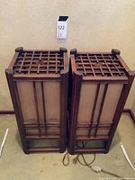 Front view of both lamps showing wooden grid top, frosted glass panels, cords and plugs