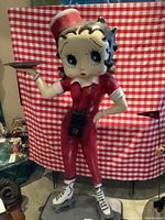 Front view of full statue on base against checkered backdrop