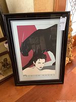 Full front view of framed print leaning against wall