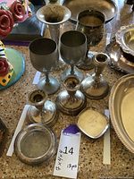 View showing all 13 pieces including candlesticks, goblets, ashtrays, and plates arranged on table.