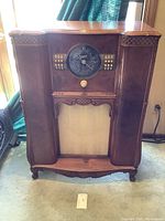 Front view of entire Zenith console radio showing wood cabinet, dial and speaker grille