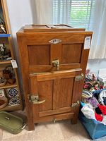 Front view of wooden cabinet with VETO emblem, door, brass hardware