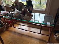 Front view of the rectangular glass-top coffee table showing overall design and condition