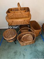 Overview of all seven Longaberger baskets and metal stand arranged on floor.