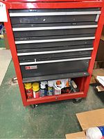 Front view of red Craftsman rolling tool cart on casters showing drawers and bottom shelf storage.