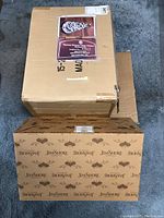 Photos of original packaging for Thomas Kinkade illuminated tree and Jim Shore figurine boxes.