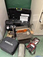 Overview of all tools including Campbell Hausfeld air compressor, Dremel drill press, Dremel mini table saw, Kensun inflator, and electronic testers shown together.