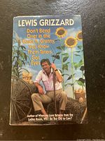 Front cover of the book showing author Lewis Grizzard sitting in a garden with sunflowers and potatoes, title and author name prominently displayed.