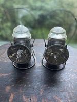 Front view of the two metallic electric railroad lanterns showing the clear glass domes and front reflectors.