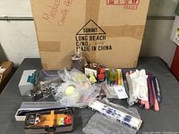 Photo showing all candles, candle holder box, snuffer and items laid out