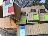 Boxes of green and red covers for bamboo director chairs, showing packaging details and quantity.