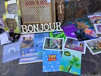 Overall view of Disney lithographs, Bonjour sign, wooden gate, and tribal mask