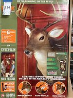 Box packaging showing image and description of Buck animated trophy, singing and moving features, holiday edition with Santa cap and scarf