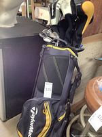 TaylorMade black and yellow stand golf bag loaded with clubs