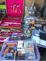 Overall view of Thai flatware cases and DVDs spread on table