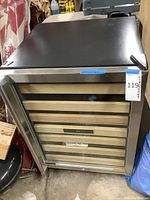 Side and front view of the black wine cellar refrigerator with glass and stainless steel door.