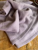 Close-up of the folded lilac wool blanket showing texture and edges