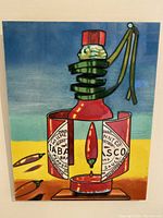Front view of the colorful hand painted ceramic tile showing hot pepper sauce bottle and red peppers