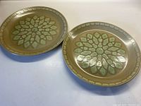 Two Johnson Bros. Stonecrest Rio Verde ceramic dinner plates showing full top view with leaf motif and border design.