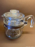 Classic vintage Pyrex coffee percolator assembled, showing clear glass with lid and handle, holding 6 cups.