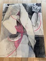 Full view of the unsigned abstract charcoal drawing with red highlights on paper, showing composition and size.
