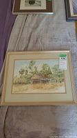 Photo of framed watercolor painting showing full artwork, frame, and price tag.