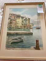 Framed original watercolor art showing a port scene with boats and buildings, signed by artist in 1966.