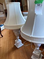 Front view of both lamps side by side showing marble bases and fabric shades