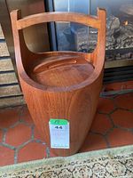 Full view of the teak ice bucket showing its curved handle and teak body.