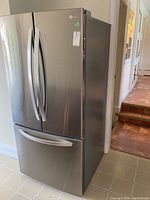 Front and right-side view of stainless steel LG refrigerator with French doors and lower freezer drawer