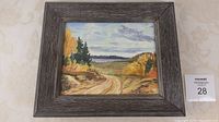 Full view of the framed 11 x 13 inch oil painting on masonite showing a fall landscape with road winding towards a lake under a cloudy sky, framed in gray wood.