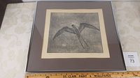 Framed etching artwork visible with auction lot tag