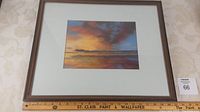 Framed painting with ruler showing frame size around 17x21 inches